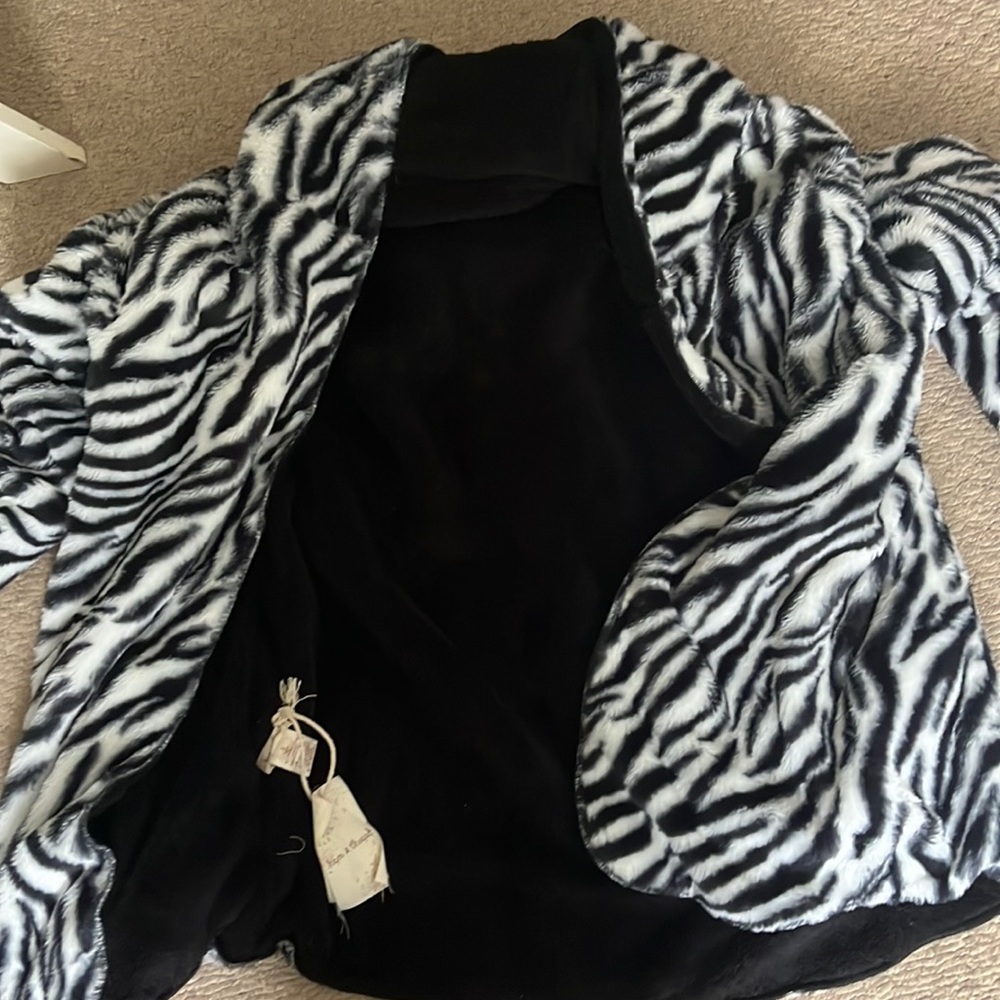Zebra reversible jacket flips into black